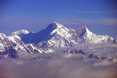 Kangchenjunga 01 04 Mountain Flight Shishapangma Long View Shishapangma, the 14th highest mountain in the world at 8012m, shines in the early morning sun from Kathmandus Mountain flight. The steep and treacherous southwest face is in shadow on the left. The north face is just visible in the sun on the right. On the far right the pointy rocky peak is Phola Gangchen (7716m), first climbed in 1981, and to its left is Shishapangmas East face.